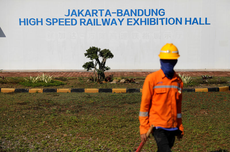 © Reuters. Worker stands in front of Jakarta-Bandung High Speed Railway exhibition hall at Walini tunnel construction site in West Bandung regency