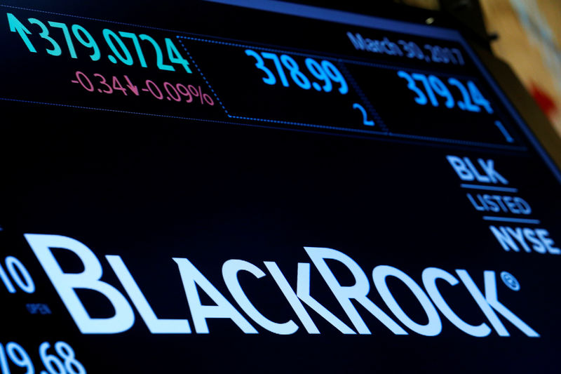 © Reuters. The company logo and trading information for BlackRock is displayed on a screen on the floor of the NYSE