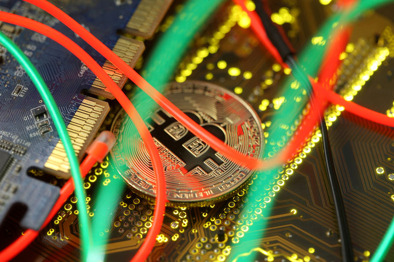 © Reuters. FILE PHOTO: Representation of the Bitcoin virtual currency standing on a PC motherboard
