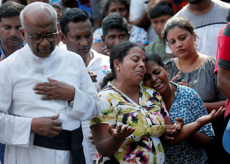 © Reuters. FOTO DE ARCHIVO: La gente reacciona durante un entierro masivo de víctimas, dos días después de una serie de atentados suicidas con bombas en iglesias y hoteles en Colombo