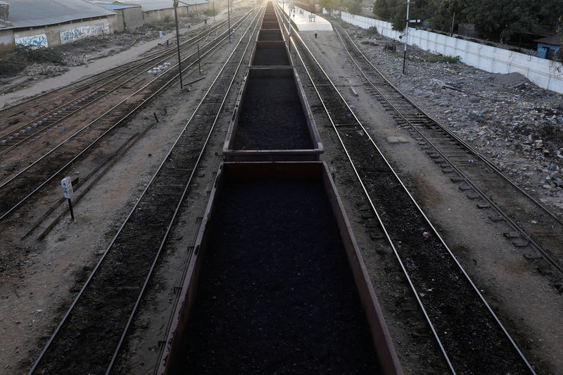 © Reuters. A cargo train loaded with coal dust, moves past the port area near City Station in Karachi