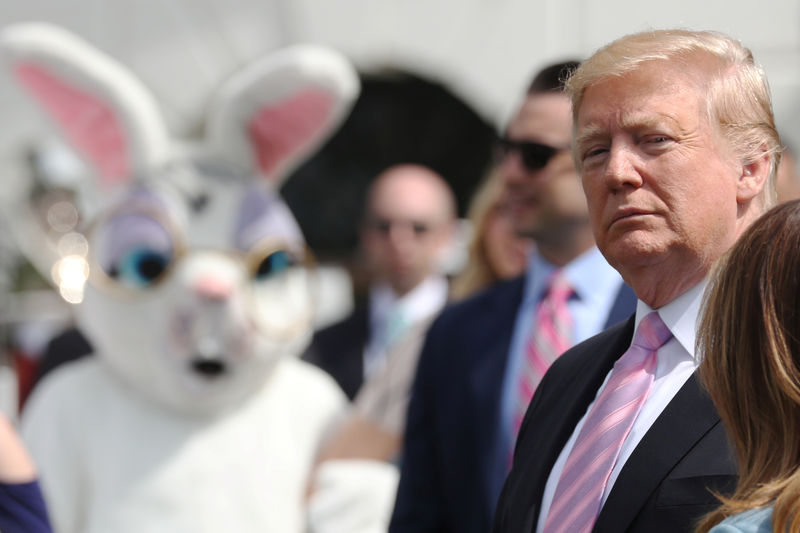 © Reuters. A person in an Easter Bunny costume looks on as U.S. President Trump attends the 2019 White House Easter Egg Roll in Washington