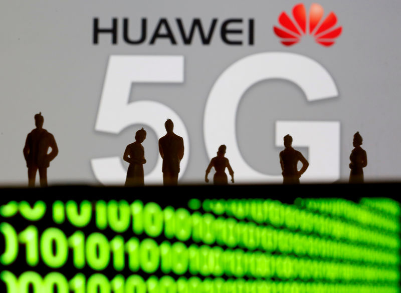 © Reuters. FILE PHOTO: Small toy figures are seen in front of a displayed Huawei and 5G network logo in this illustration picture