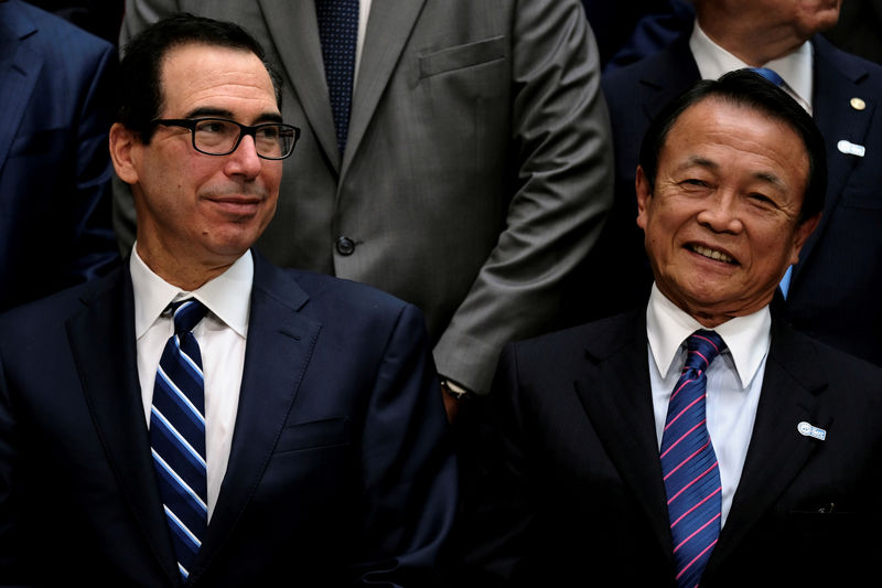 © Reuters. FILE PHOTO: U.S. Treasury Secretary Steven Mnuchin and Japanese Finance Minister Taro Aso attend the IMF and World Bank's 2019 Annual Spring Meetings, in Washington