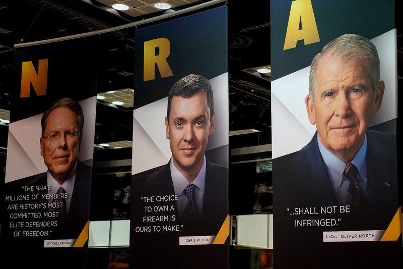 © Reuters. Images of NRA CEO Wayne LaPierre, Legislative Director Chris Cox and President Oliver North displayed during the National Rifle Association (NRA) annual meeting at the Indiana Convention center in Indianapolis