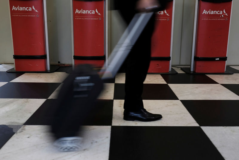 © Reuters. A customer walks past Avianca airline check-in machines at Congonhas airport in Sao Paulo