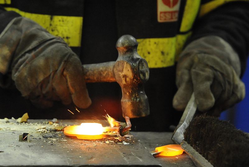 © Reuters. A steel sample is taken by a worker at the SSI steel plant at Redcar