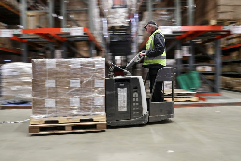 © Reuters. An employee operates a forklift to move goods at the Miniclipper Logistics warehouse in Leighton Buzzard