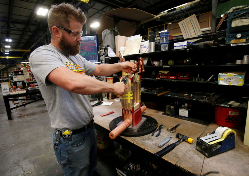 © Reuters. FILE PHOTO: Sub-assembly worker Joel Dykema works on the sub-assembly of a transformer in the RoMan Manufacturing plant in Grand Rapids, Michigan