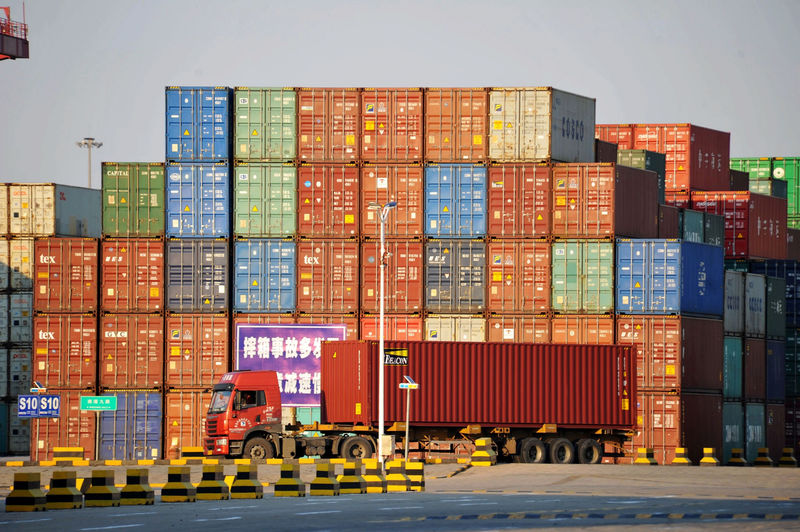 © Reuters. Truck transports a shipping container at Qingdao port in Shandong