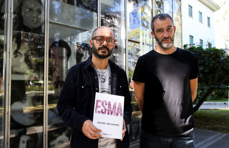 © Reuters. Juan Carra and Inaki Echeverria, authors of the graphic novel "ESMA", pose for a picture at the Naval Mechanics School, known as ESMA, in Buenos Aires