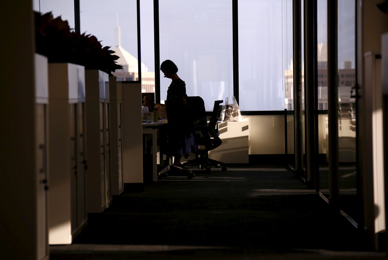 © Reuters. FILE PHOTO: An employee of software company Nuix stands in their office located in central Sydney, Australia