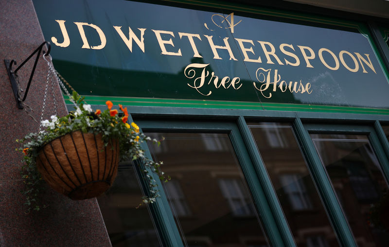 © Reuters. A Wetherspoon's logo is seen at a pub in central London