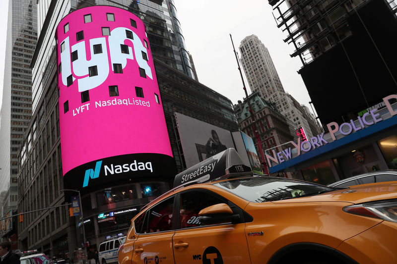 © Reuters. FILE PHOTO: Signage for Lyft is seen displayed at the NASDAQ MarketSite in Times Square in celebration of its initial public offering (IPO) on the NASDAQ Stock Market in New York