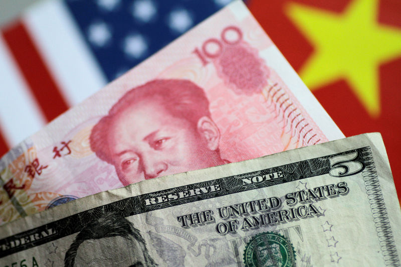 © Reuters. FILE PHOTO: Illustration photo of U.S. dollar and China yuan notes