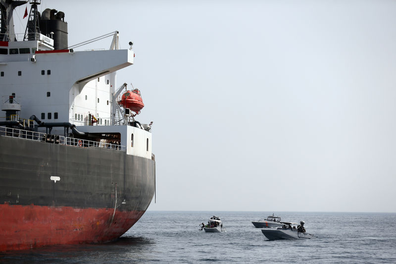 © Reuters. UAE Navy boats next to Al Marzoqah Saudi Arabia tanker are seen off the Port of Fujairah