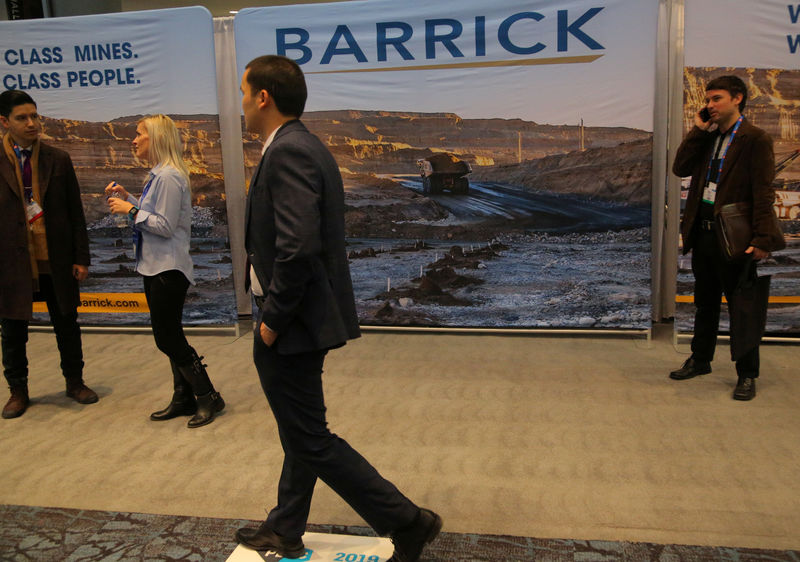 © Reuters. A visitor passes a Barrick Gold mining company display during the PDAC convention in Toronto
