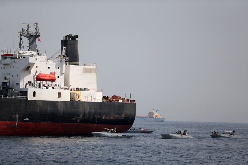 © Reuters. FILE PHOTO:  UAE Navy boats are seen next to Al Marzoqah, Saudi Arabian tanker, off the Port of Fujairah