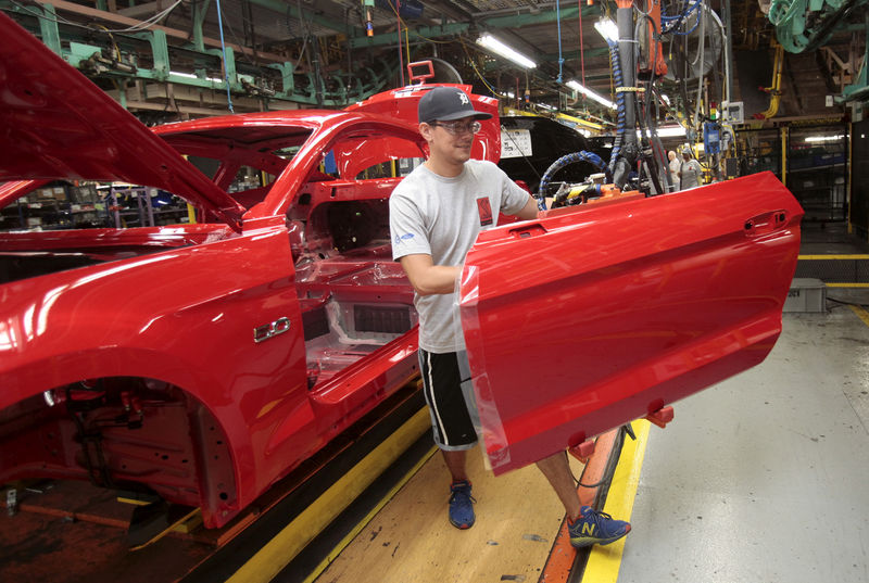 © Reuters. FILE PHOTO: A Ford Motor assembly worker works on a Ford Mustang vehicle at the Ford Motor Flat Rock Assembly Plant in Flat Rock, Michigan