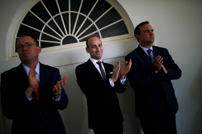 © Reuters. White House acting chief of staff Mulvaney and aides Miller and Scavino applaud U.S. President Trump speaking about U.S. immigration policy at White House in Washington