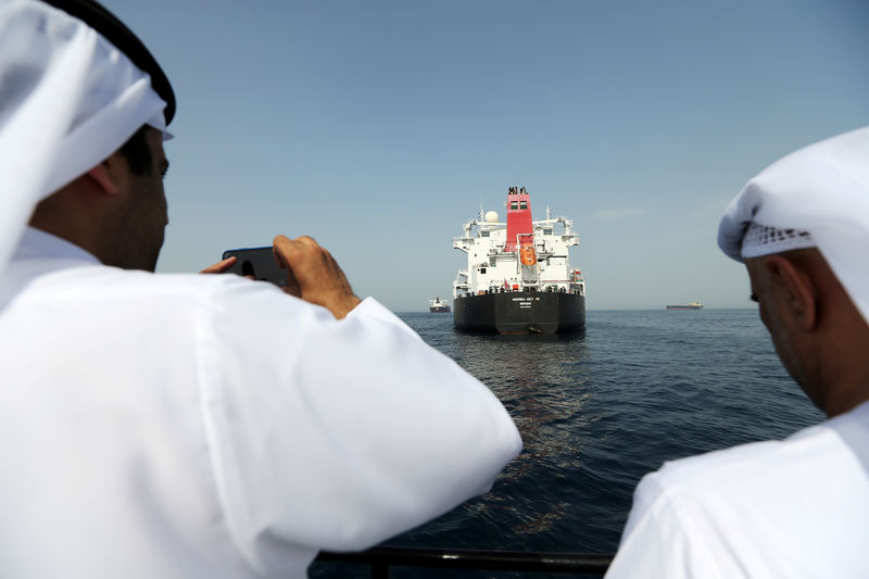 © Reuters. FILE PHOTO: Port officials take a photo of the damaged tanker Andrea Victory at the Port of Fujairah