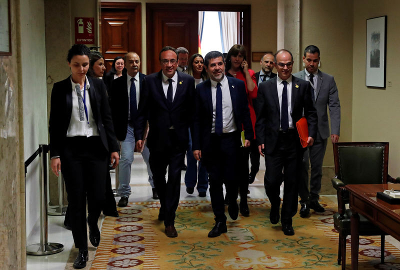 © Reuters. Los políticos catalanes encarcelados Josep Rull, Jordi Sánchez y Jordi Turull se marchan tras recibir sus credenciales parlamentarias