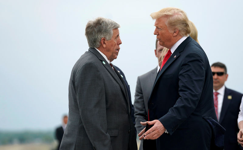 © Reuters. U.S. President Trump speaks with the Governor of Missouri Parson as he arrives in St. Louis, Missouri