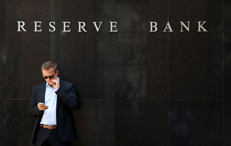 © Reuters. A man smokes next to the Reserve Bank of Australia headquarters in central Sydney