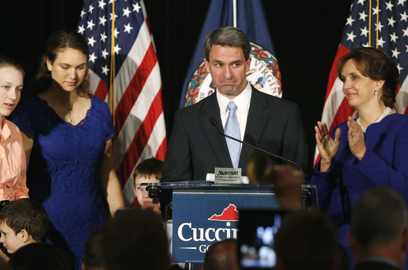 © Reuters. Cuccinelli stands onstage with his wife and their family as he gives his concession speech at his election night event in Richmond, Virginia