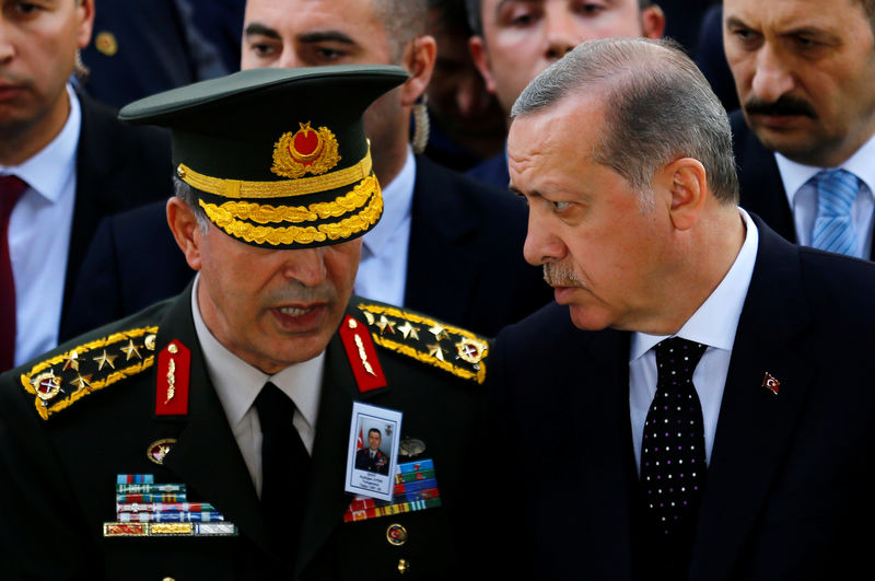 © Reuters. Turkish President Tayyip Erdogan and Chief of Staff General Hulusi Akar chat as they attend the funeral of Major General Aydogan Aydin in Ankara