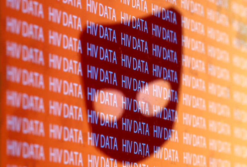 © Reuters. The Grindr logo is reflected on "HIV Data" text in this picture illustration
