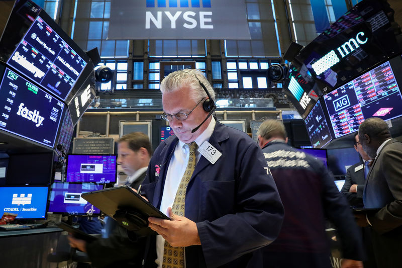 © Reuters. FILE PHOTO: Traders work on the floor at the NYSE in New York