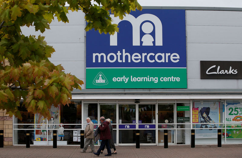 © Reuters. People walk past a Mothercare store in Altricham