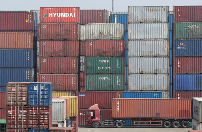 © Reuters. A container is transported into a logistics center near Tianjin Port