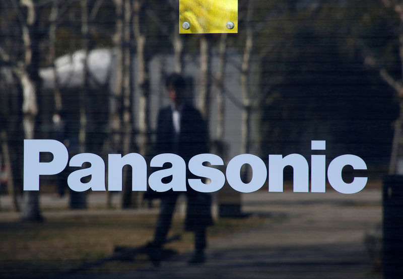 © Reuters. FILE PHOTO: A man is reflected on Panasonic Corp's logo at Panasonic Center in Tokyo