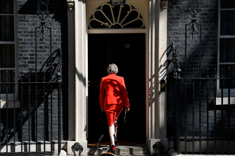 © Reuters. British Prime Minister Theresa May leaves after delivering a statement in London