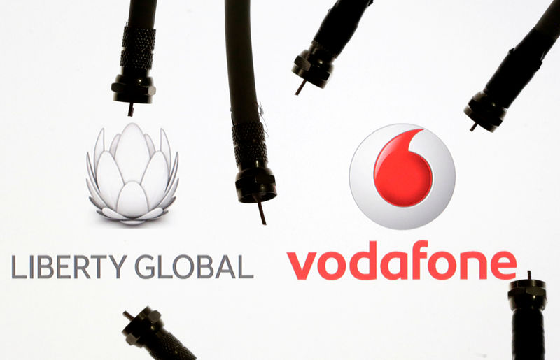 © Reuters. FILE PHOTO: Coaxial TV Cables are seen in front of Vodafone and Liberty Global logos in this illustration