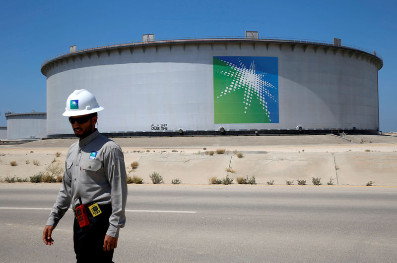 © Reuters. Foto de archivo de un empleado de Aramco cerca de un tanque de petróleo en la refinería y terminal de Ras Tanura en Arabia Saudita