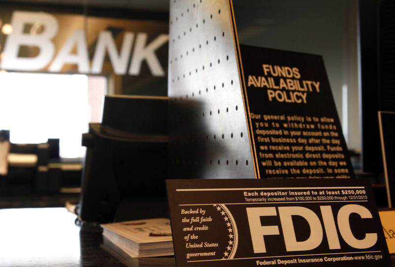 © Reuters. Signs explaining Federal Deposit Insurance Corporation (FDIC) and other banking policies are shown on the counter of a bank in Westminster