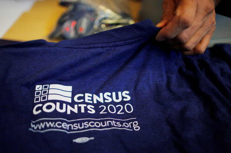 © Reuters. FILE PHOTO: T-shirts are displayed at a community activists and local government leaders event to mark the one-year-out launch of the 2020 Census efforts in Boston