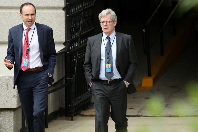 © Reuters. FILE PHOTO: White House legal counsel Flood, walking with Associate Counsel Morrell, exits the Eisenhower Executive Office Building on the White House campus in Washington