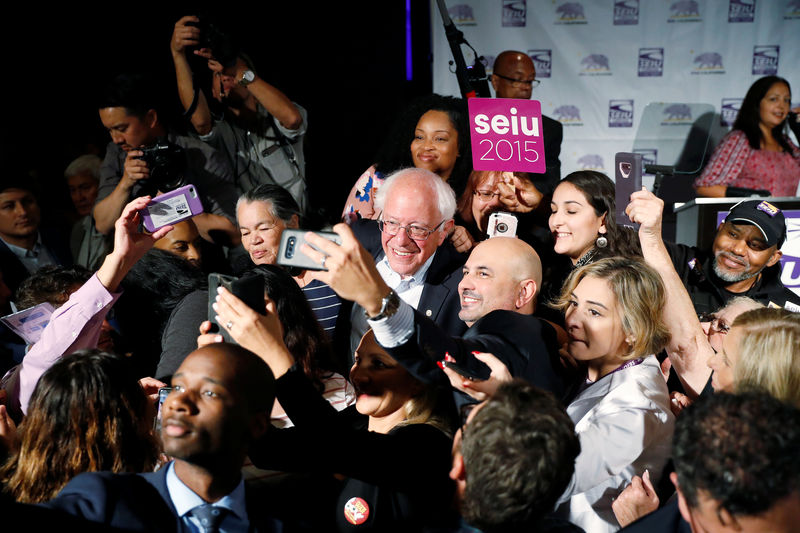 © Reuters. Democratic presidential candidate and U.S. Senator Bernie Sanders takes a selfie with supporters during a SEIU California Democratic Delegate Breakfast in San Francisco, California