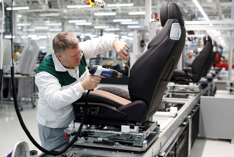 © Reuters. FILE PHOTO: A worker irons the leather on a seat at Bentley's manufacturing facility in Crewe