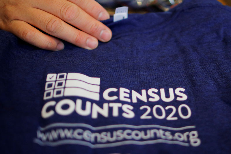 © Reuters. FILE PHOTO: T-shirts are displayed at a community activists and local government leaders event to mark the one-year-out launch of the 2020 Census efforts in Boston