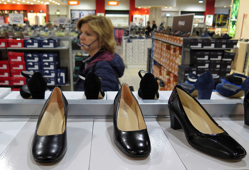 © Reuters. A woman looks for shoes in a shop in Rome