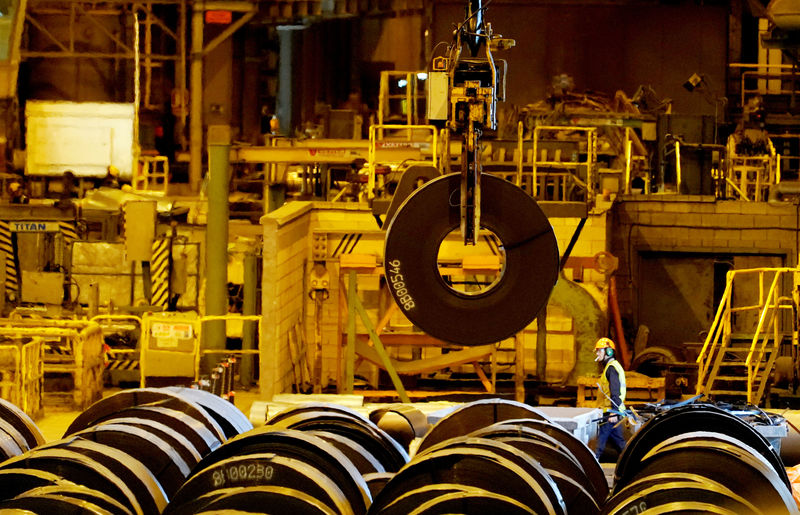 © Reuters. FILE PHOTO: A steel roll is moved by the crane at the ArcelorMittal steel plant in Sestao