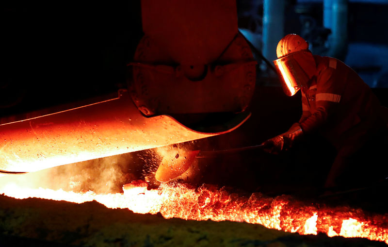 © Reuters. FILE PHOTO: A steel worker of Germany's industrial conglomerate ThyssenKrupp AG works near a blast furnace at Germany's largest steel factory in Duisburg