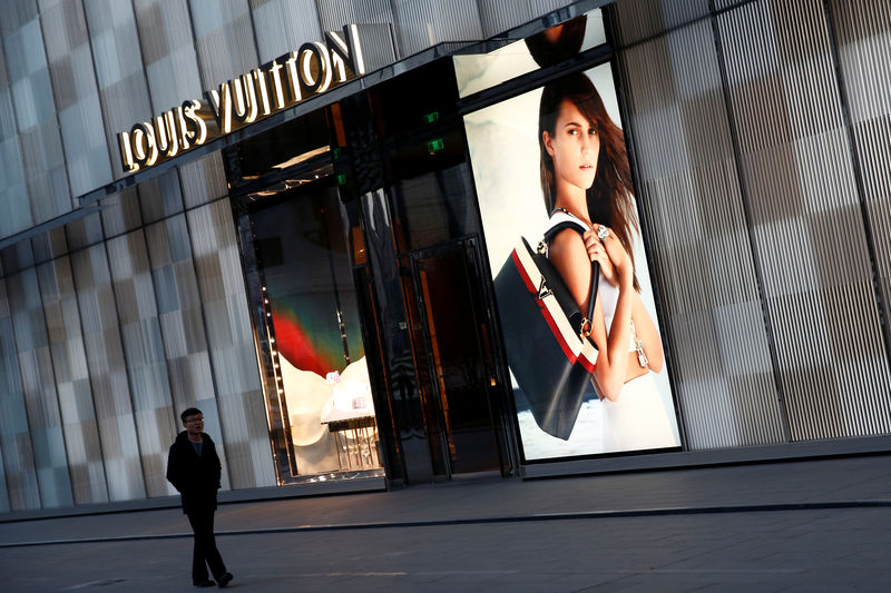 © Reuters. A man walks past a boutique of the Louis Vuitton luxury goods company in Beijing