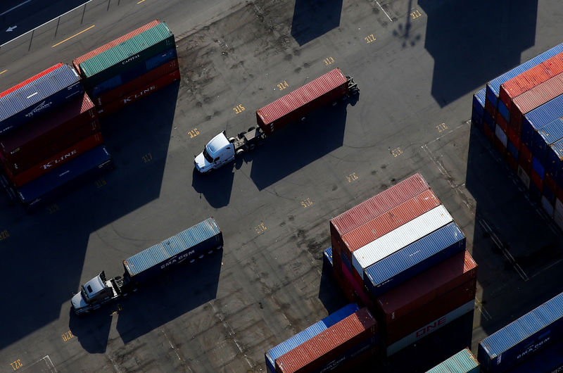 © Reuters. FILE PHOTO: An aerial photo shows shipping containers loaded onto trucks at Harbor Island at the Port of Seattle in Seattle