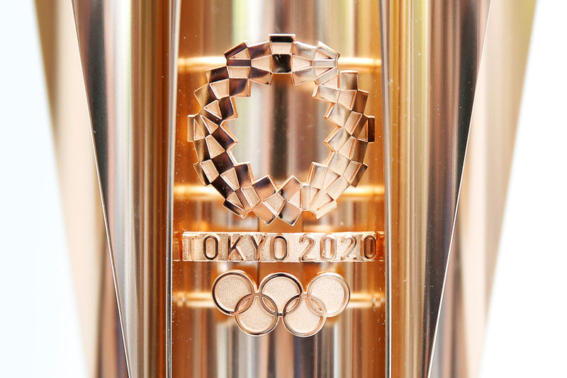 © Reuters. The Olympic torch of the Tokyo 2020 Olympic Games is displayed at a Torch Relay event to mark the 300-day milestone to the starting date of the torch relay, in Tokyo